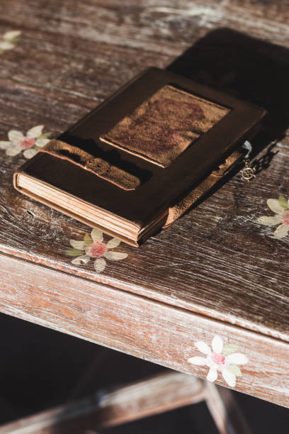 istock Vintage notebook with leather cover on the wooden table 896472644
