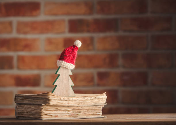 istock Santa Claus Christmas hat and tree with old books 896472754