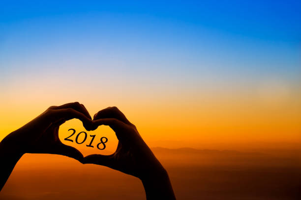 istock Silhouette 2018 in hand. Background sunrise 896482620