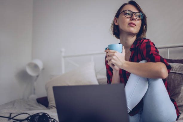 istock Girl sitting on bed 896492502