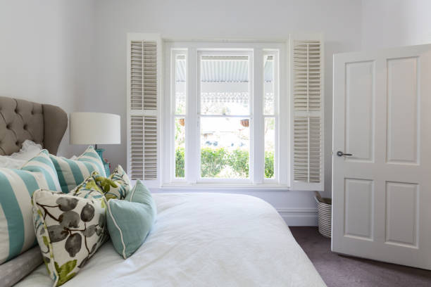 Bedroom window with a garden view in a luxury country house bedroom Bedroom window with a garden view in a luxury country house bedroom the hamptons photos stock pictures, royalty-free photos & images
