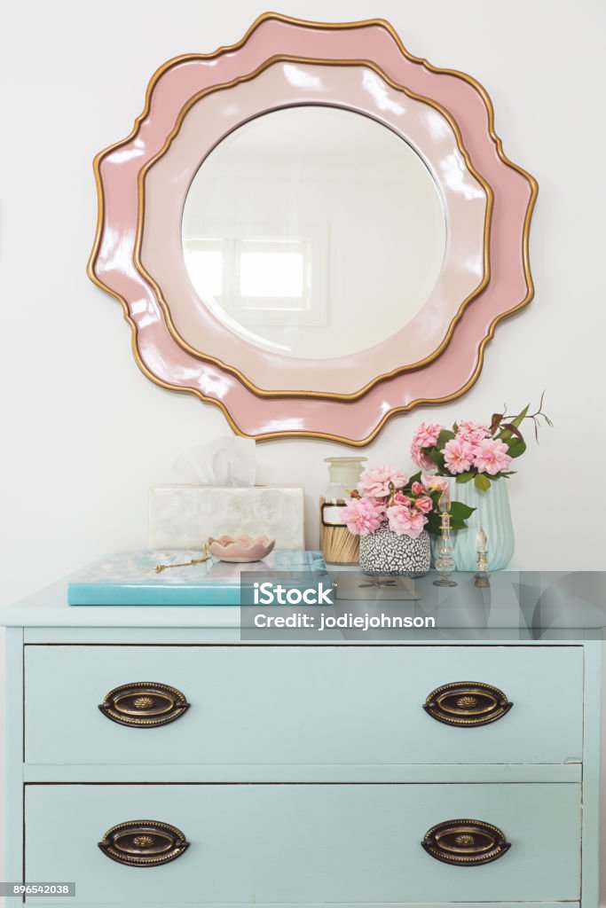 Pretty pastel blue and pink styled dressing table bedroom decor with flowers and mirror Home Showcase Interior Stock Photo