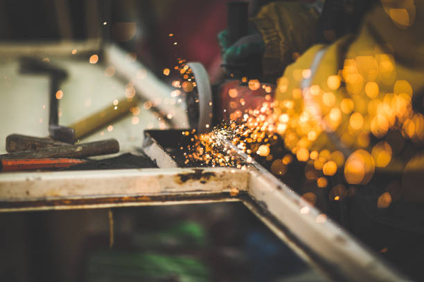 istock Craftsman sawing metal with disk angle grinder in a warehouse. 896556030