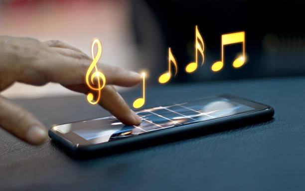 istock Abstract hand playing music notes on smartphone at night background, music concept, All on mobile screen are design up. 896567258