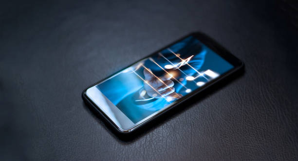 istock Abstract hand playing music notes on smartphone at night background, music concept 896569920