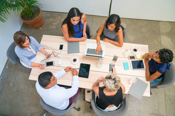 istock Group of employees around table reaching a decision 896586628