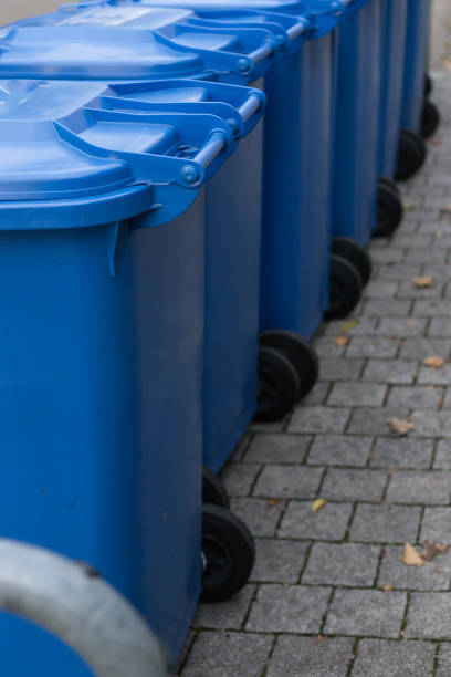 istock blue dustbin in a row on street 896596916