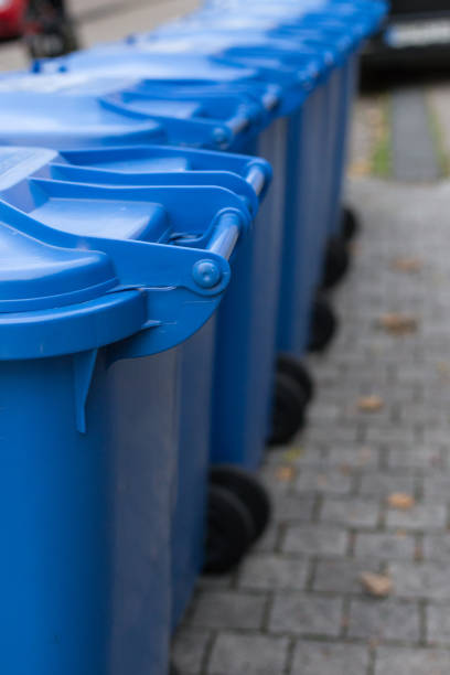 istock blue dustbin in a row on street 896596930