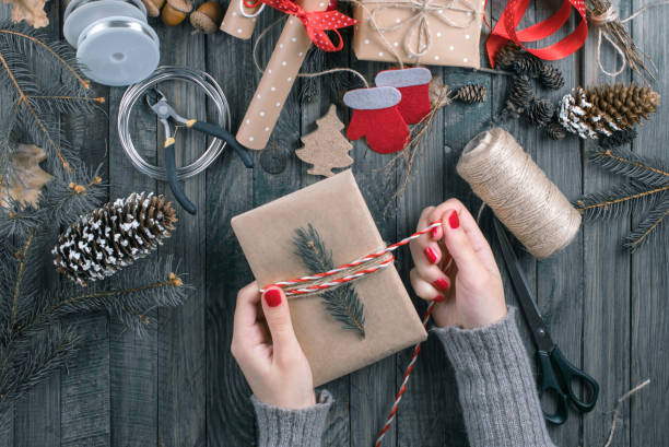 istock Girl hands holding present for Christmas. Top view. 896654174