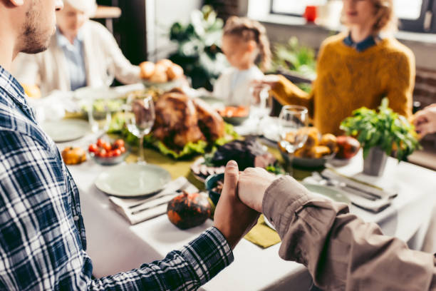 istock family holding hands and praying on thanksgiving 896667490