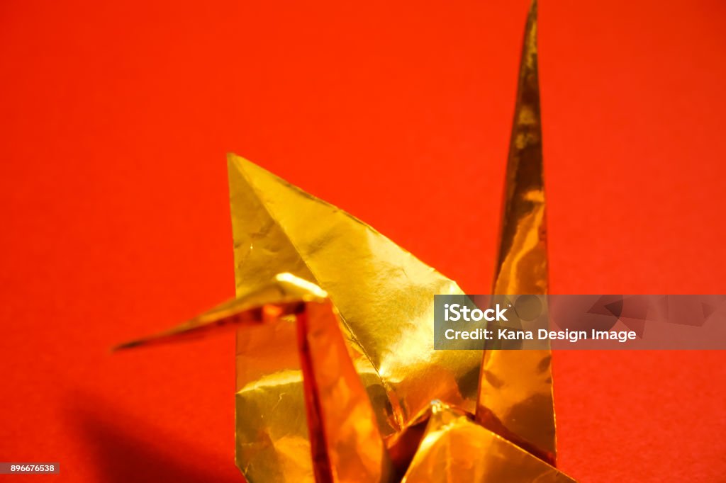 Celebration material of Japan. Golden folded-paper crane. red background Award Stock Photo