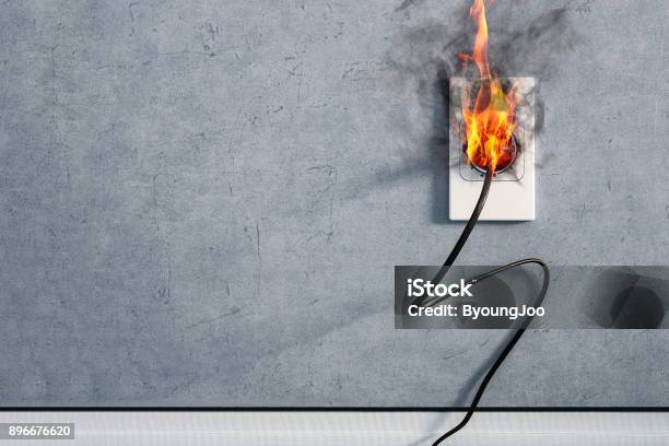 Fire And Smoke On Electric Wire Plug In Indoor Electric Short Circuit Causing Fire On Plug Socket Stock Photo - Download Image Now