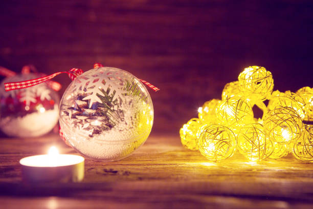 istock Christmas decorations with Christmas lights on wooden table. Toned image 896682866