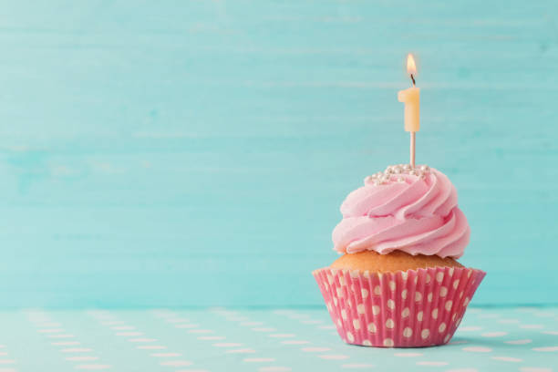 istock birthday caucpcake on blue wooden background 896690186