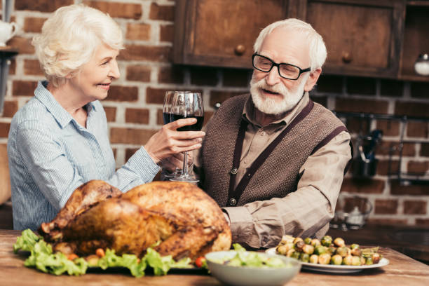 istock senior couple drinking wine on thanksgiving 896698130