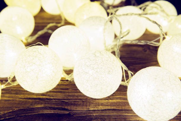 istock Christmas lights decorations laying on a rustic wooden table. Christmas or New Year concept. Toned image 896710002