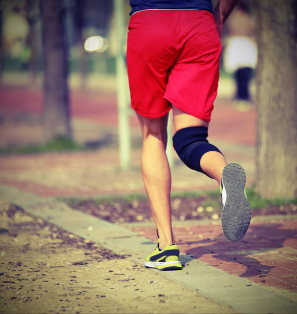 istock athlete runs the race with the knee bandage with vintage effect 896718980