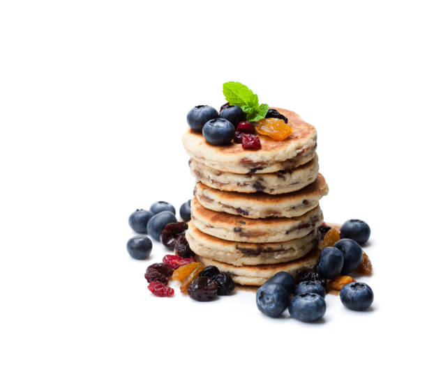 istock Stack  of welsh cakes with dry berries and fresh blueberries isolated on white 896723806