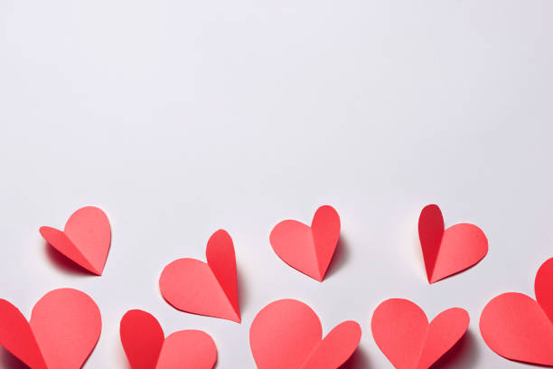 istock Beautiful red paper hearts on white paper background 896734182