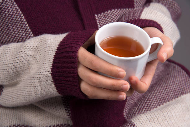 istock Hand Holding A Cup Of Herbal Tea 896741222