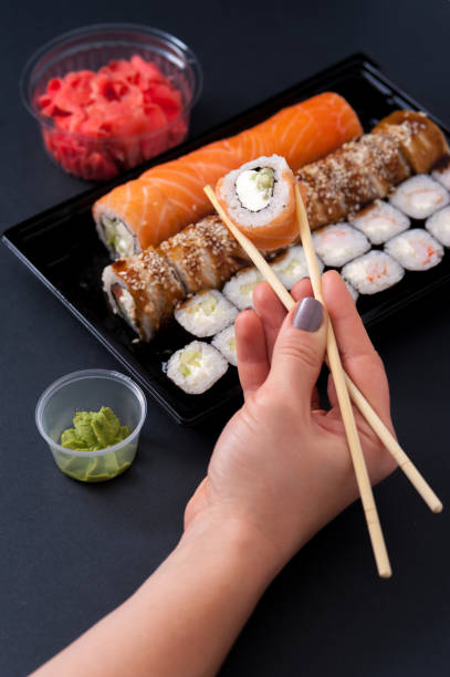 istock Sushi rolls set with wasabi, ginger and chopsticks 896741658
