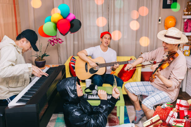 happy family, brotherhood and friends playing music in the party at home - jam up imagens e fotografias de stock