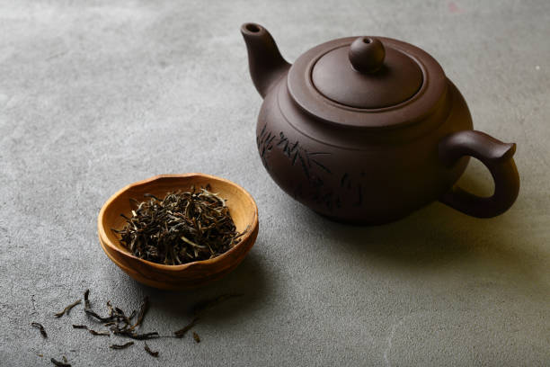 istock Brown teapot and green tea in bowl, beverage 896746410