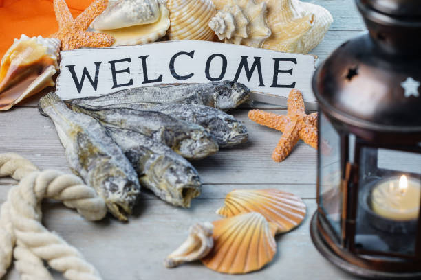 istock Welcome wooden board with fish dry goby. 896749424