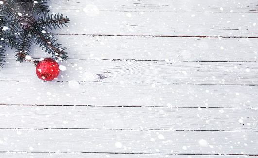 New Year's background. Spruce branches on a wooden table. Ornaments for the New Year tree. Christmas concept