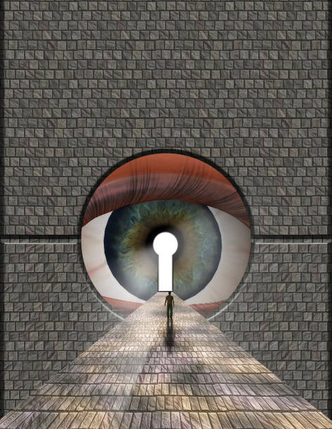 istock Man ventures toward large eye keyhole 896756462