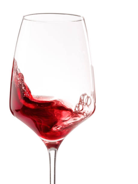 istock One glass with red wine. Isolated on white. Close-up. 896764814