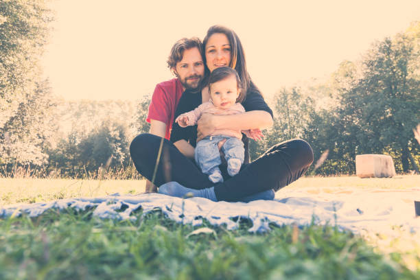 istock Young family having picnic in a park 896764980