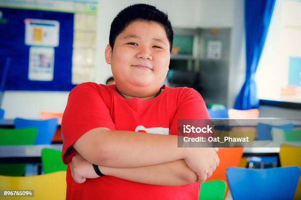 Asian Obese Boy Standing Crossed Arms And Cute Smile Stock Photo - Download Image Now