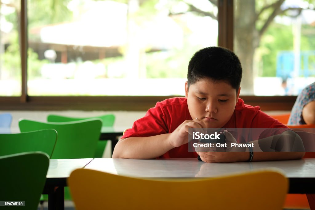 Asian child Boy are addictive playing tablet and mobile phones, Game Addiction Child Stock Photo
