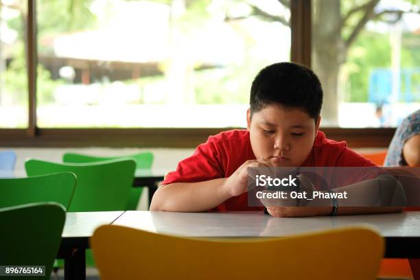 Asian Child Boy Are Addictive Playing Tablet And Mobile Phones Game Addiction Stock Photo - Download Image Now