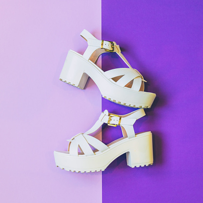 fashionable white platform sandals on ultra violet background. minimal trend