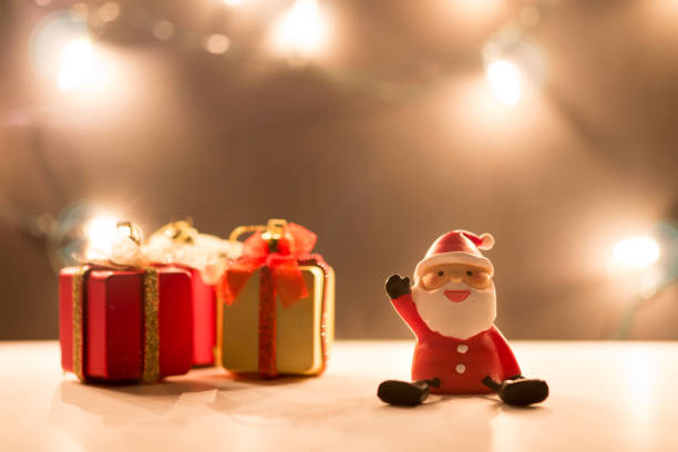 istock Santa Claus dolls and Christmas decorations box on abstract light background with copy space 896769022