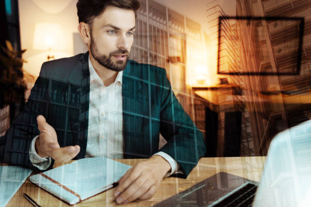 istock Handsome businessman making his point in online conference 896769346