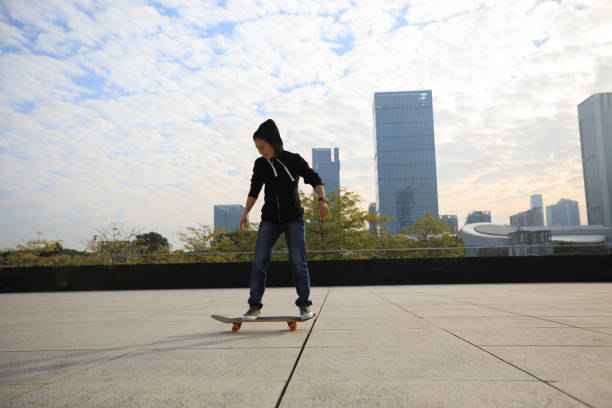 istock female skateboarder riding with skateboard on city 896772430