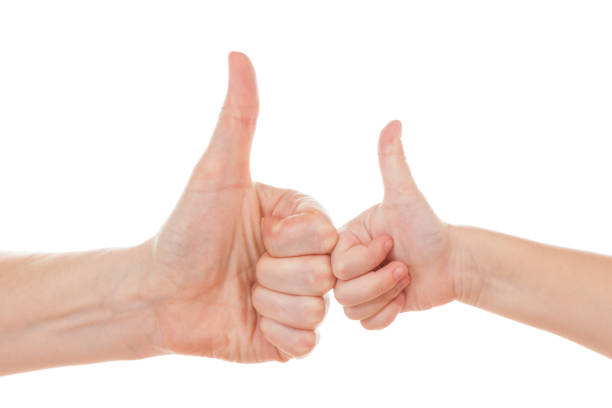 istock Female and child hands thumbs up isolated on white. 896787422