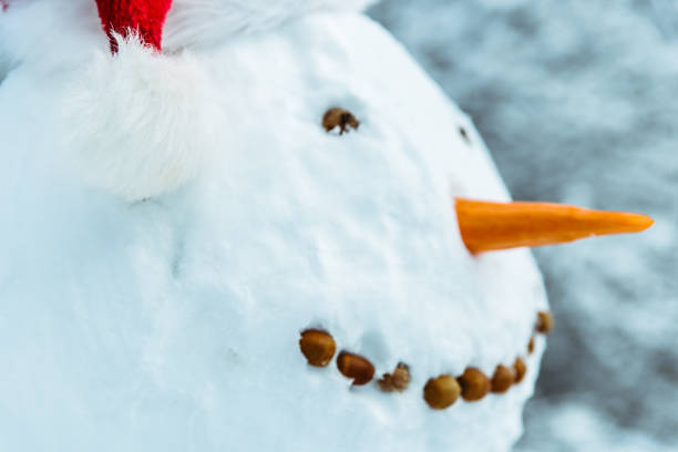 istock snow man in city park 896787932