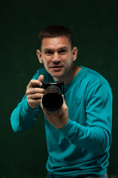 istock Smiling professional photographer with camera 896799610