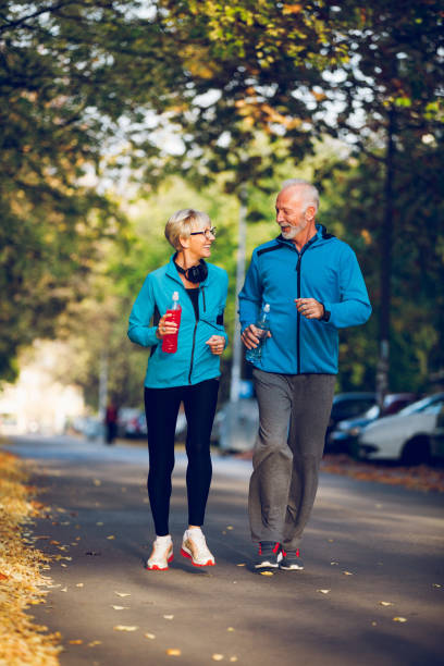 istock Senior couple walking together with water bottles. 896799656