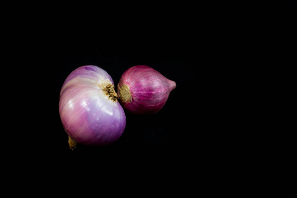 istock Red onion on black background. Shallot is used for cooking various types, especially food. 896805226