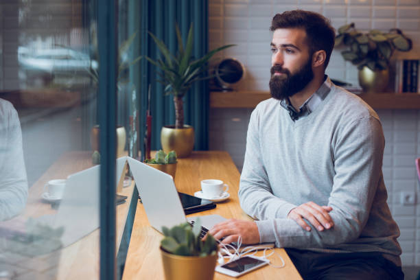 istock Trendy blogger typing on laptop in cafe. 896805550