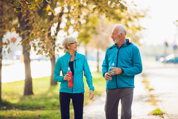 istock Senior couple walking together with water bottles 896808908