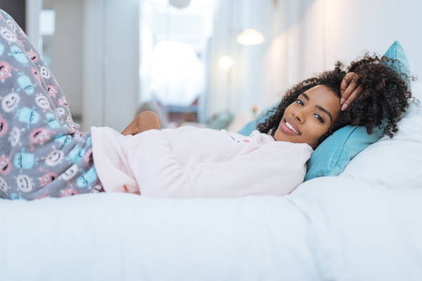 istock Happy beautiful young black woman relaxed lying down in the bed 