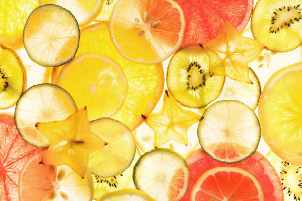 istock Backlit citrus fruits slices background 896814382