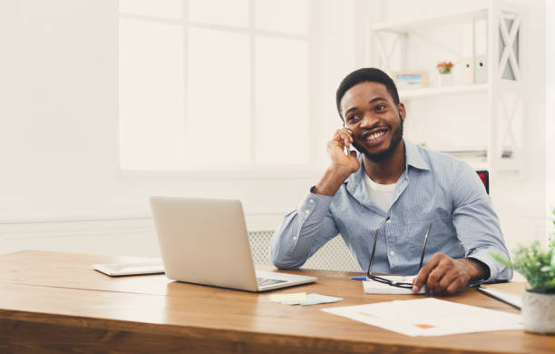 istock Young black businessman talking on mobile phone 896815040