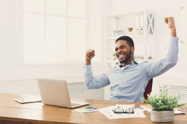 istock Happy businessman win. Winner, black man in office 896815086
